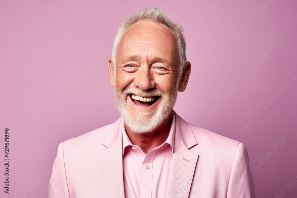 Portrait of a happy senior man in a pink suit on a pink background. Portrait of a happy senior man in a pink suit on a pink background.
