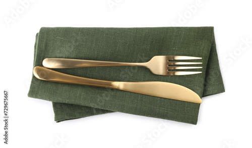 Canvastavla Green napkin with golden fork and knife isolated on white, top view