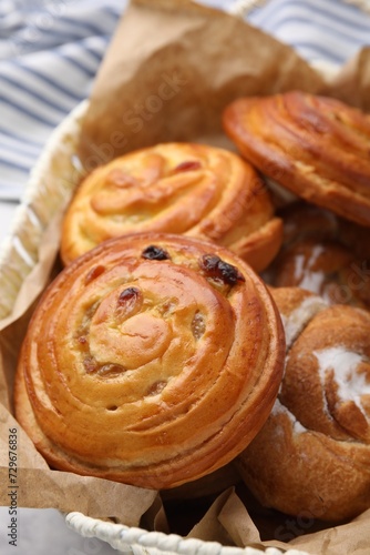 Delicious rolls with raisins and sugar powder on table, closeup. Sweet buns © New Africa