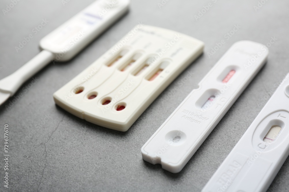 Different disposable express tests on grey table, closeup Different disposable express tests on grey table, closeup
