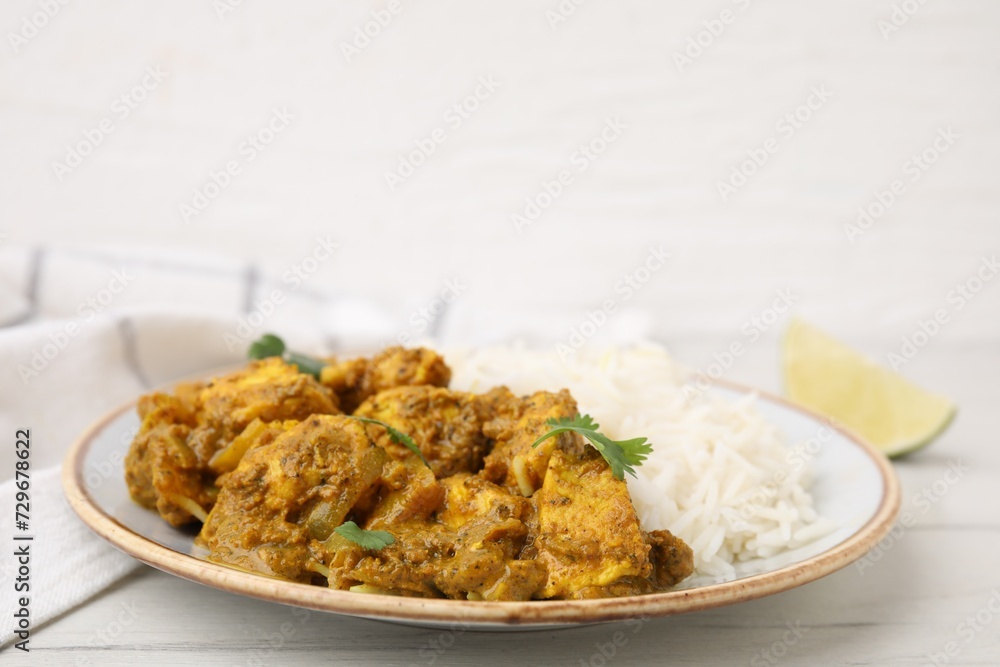 Delicious chicken curry with rice on white wooden table Delicious chicken curry with rice on white wooden table