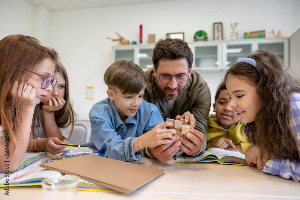 Man teacher and kids in class, learning new chemistry topic. Man teacher and kids in class, learning new chemistry topic.