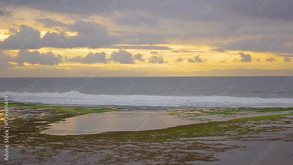 Morning atmosphere on the beach with a beautiful sunrise and waves at Sayang Heulang Beach, Garut City, indonesia Morning atmosphere on the beach with a beautiful sunrise and waves at Sayang Heulang Beach, Garut City, indonesia