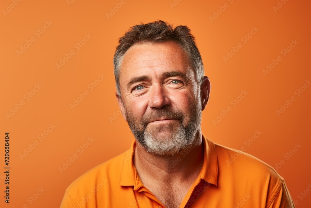 Portrait of a senior man with beard and mustache on orange background Portrait of a senior man with beard and mustache on orange background
