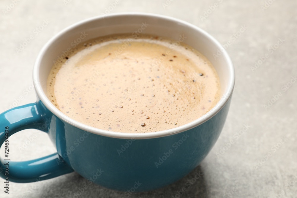 Cup of aromatic coffee on light grey table, closeup Cup of aromatic coffee on light grey table, closeup