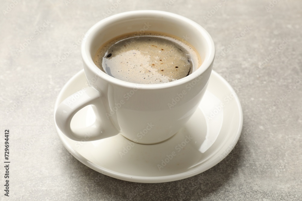 Cup of aromatic coffee on light grey table, closeup. Cup of aromatic coffee on light grey table, closeup.