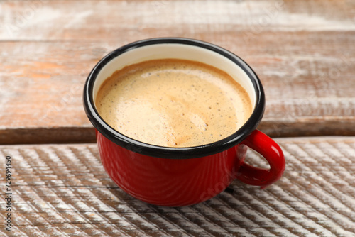 Cup of aromatic coffee on wooden table  closeup