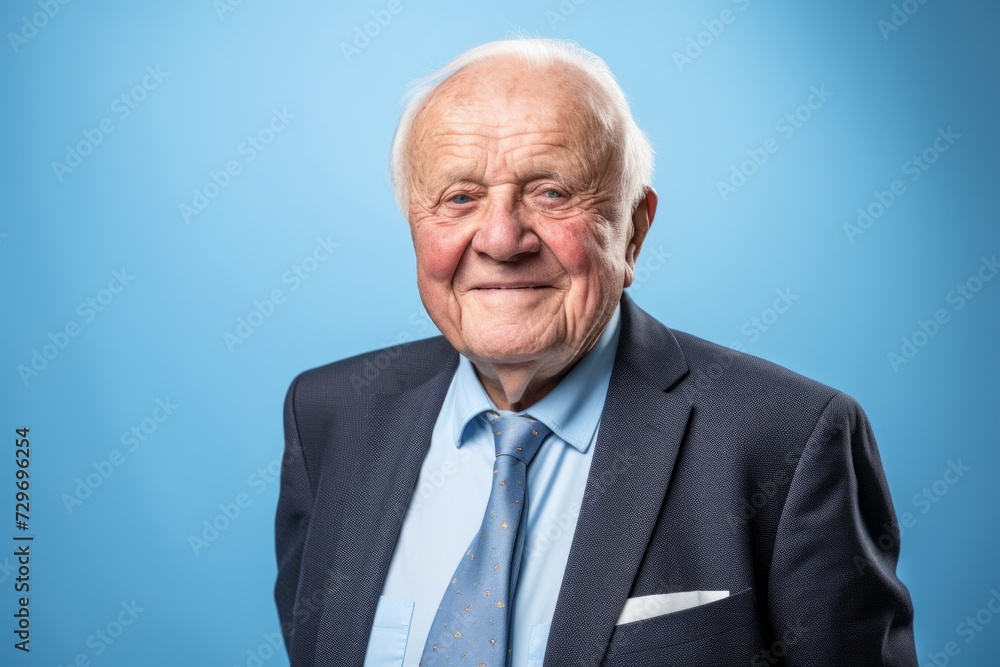 Portrait of an old man in a business suit on a blue background Portrait of an old man in a business suit on a blue background