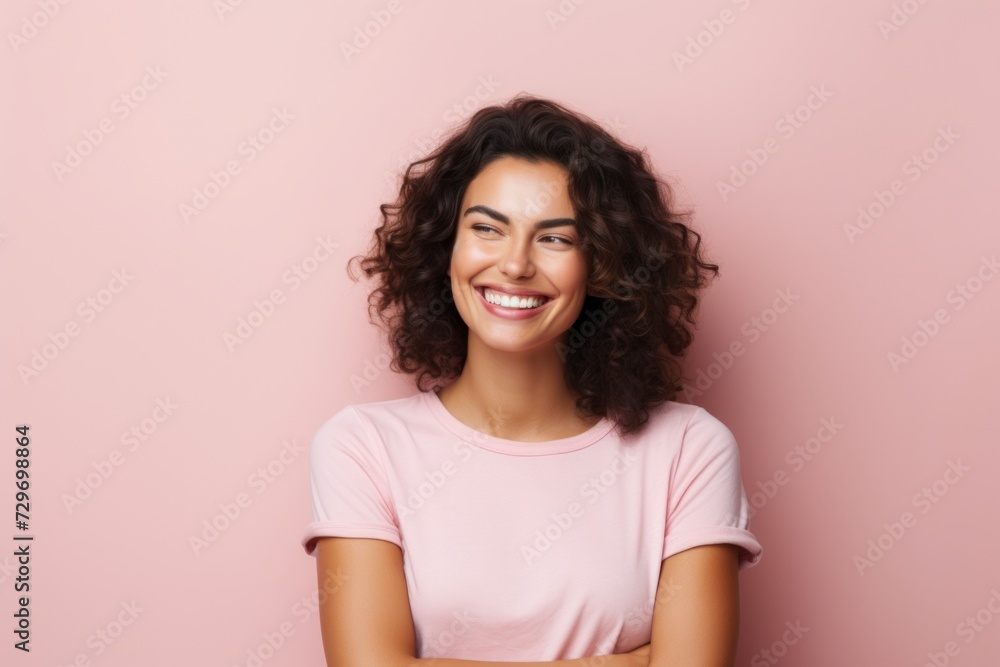 Portrait of a smiling young woman with curly hair over pink background Portrait of a smiling young woman with curly hair over pink background