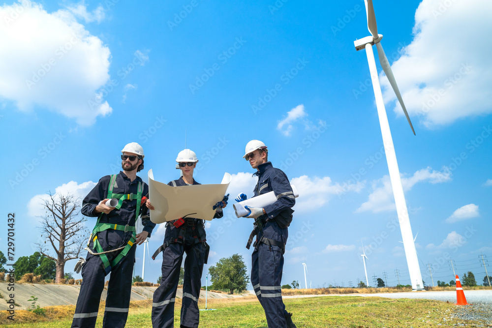 Engineers man and woman inspecting construction of WIND TURBINE FARM. WIND TURBINE with an energy storage system operated by Super Energy Corporation. Workers Meeting to check AROUND THE AREA. Engineers man and woman inspecting construction of WIND TURBINE FARM. WIND TURBINE with an energy storage system operated by Super Energy Corporation. Workers Meeting to check AROUND THE AREA.