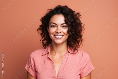 Portrait of a beautiful young woman smiling at the camera over brown background © Igor