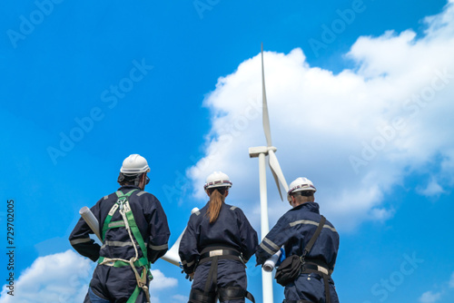 engineer working in fieldwork outdoor. Workers check and inspect construction and machine around building project site. Wind turbine for electrical of clean energy and environment sustainable.