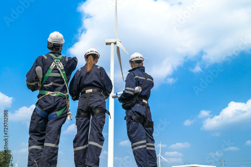 engineer working in fieldwork outdoor. Workers check and inspect construction and machine around building project site. Wind turbine for electrical of clean energy and environment sustainable.