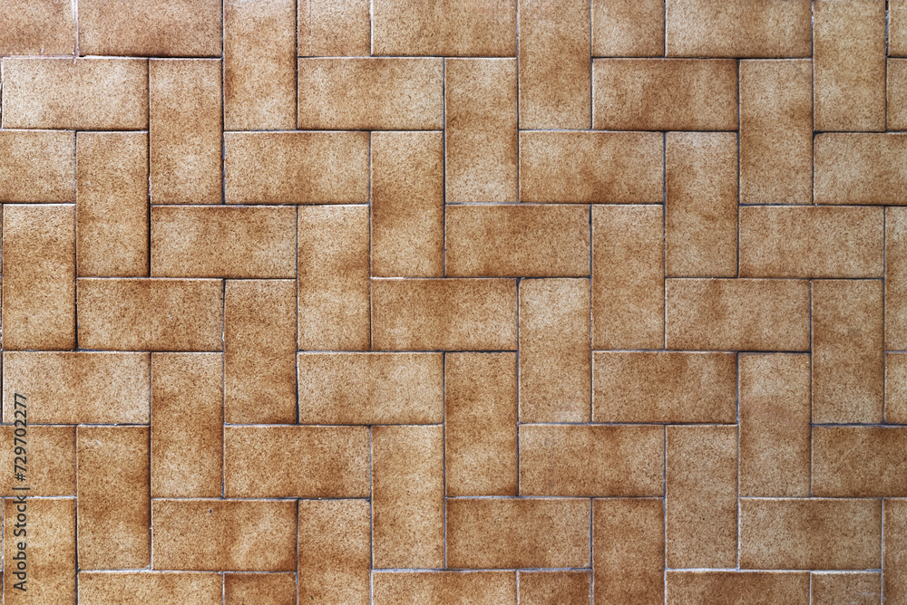 Obraz premium A wall covered in small rectangular brown tiles