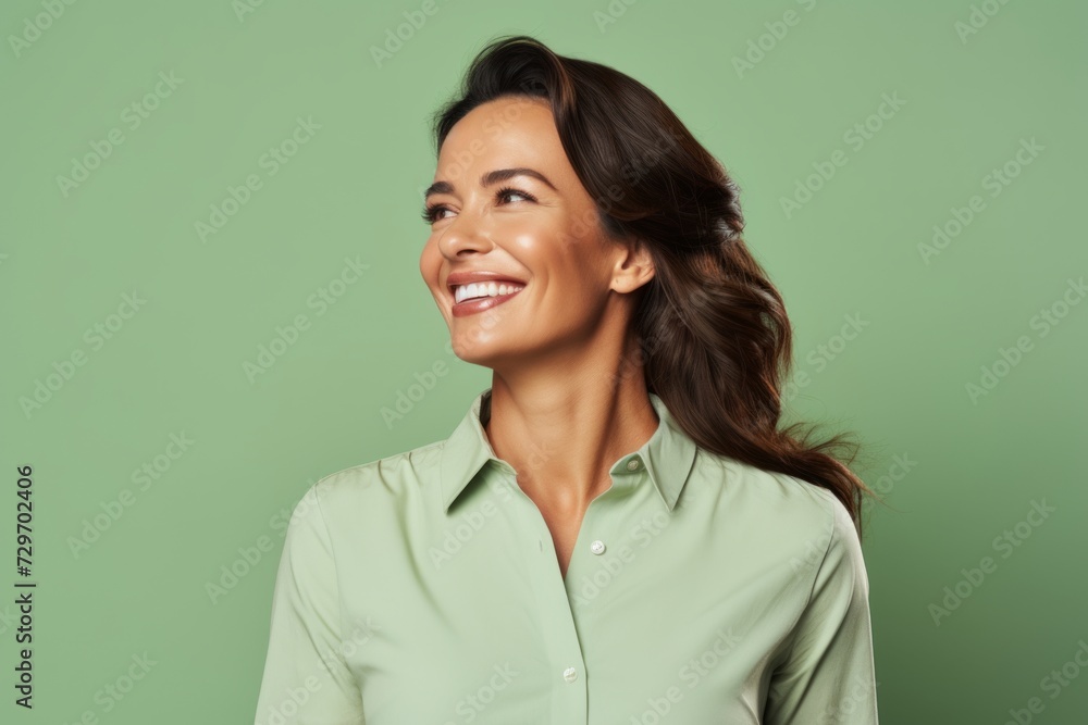 Portrait of happy smiling young woman in green shirt on green background Portrait of happy smiling young woman in green shirt on green background
