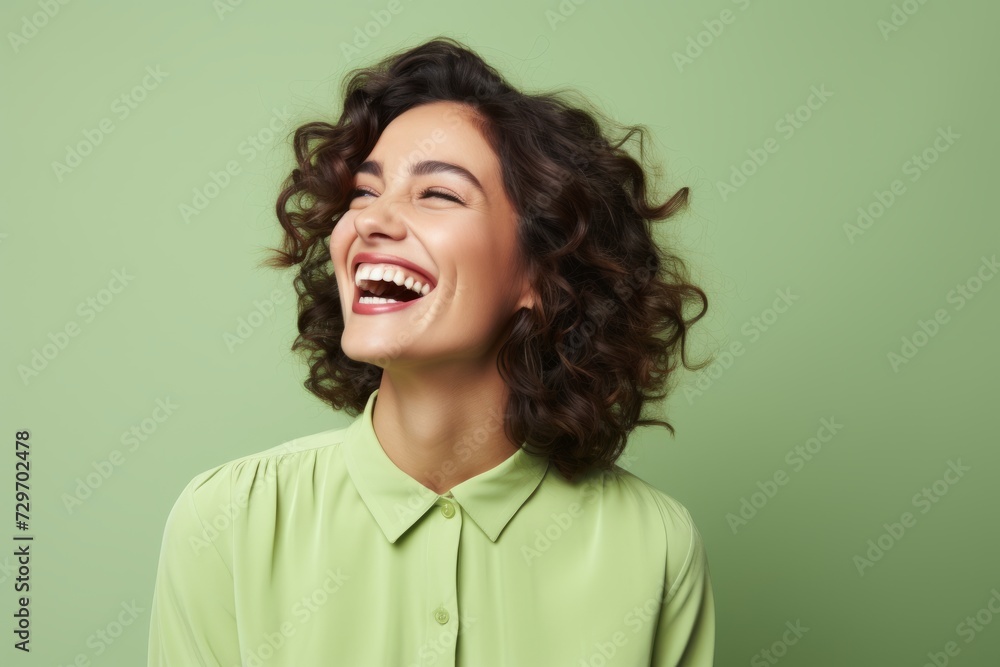 Portrait of happy smiling young beautiful woman in green shirt, over green background Portrait of happy smiling young beautiful woman in green shirt, over green background