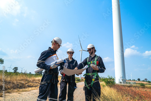 engineer working in fieldwork outdoor. Workers check and inspect construction and machine around building project site. Wind turbine for electrical of clean energy and environment sustainable.