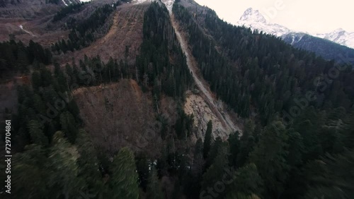 Snow-capped mountain peak. Beautiful fpv drone flight along the slope of majestic mountains
