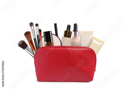 Cosmetic bag filled with makeup products on white background