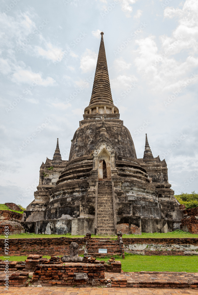 Traditional Thai stone pagoda building structure ruins at Wat Phra Si Sanphet temple in Ayutthaya Thailand historical park on a cloudy day