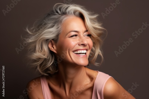 Portrait of a beautiful smiling middle-aged woman with blond hair