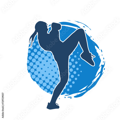 Silhouette of a female kickboxer athlete in action pose. Silhouette of a sporty woman doing kicking pose.