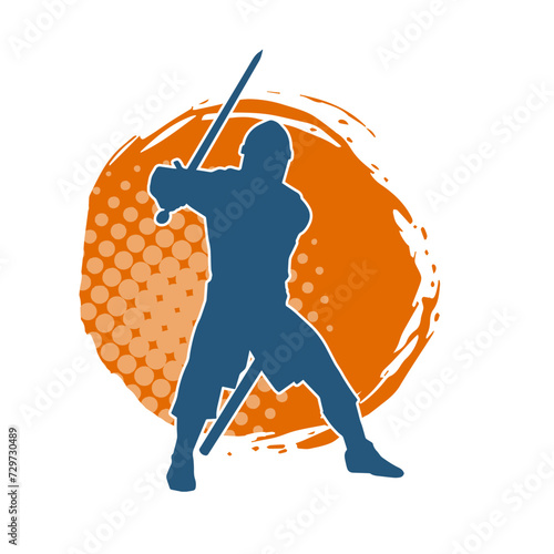 Silhouette of a male warrior wearing war armor suit in action pose using a sword weapon.
