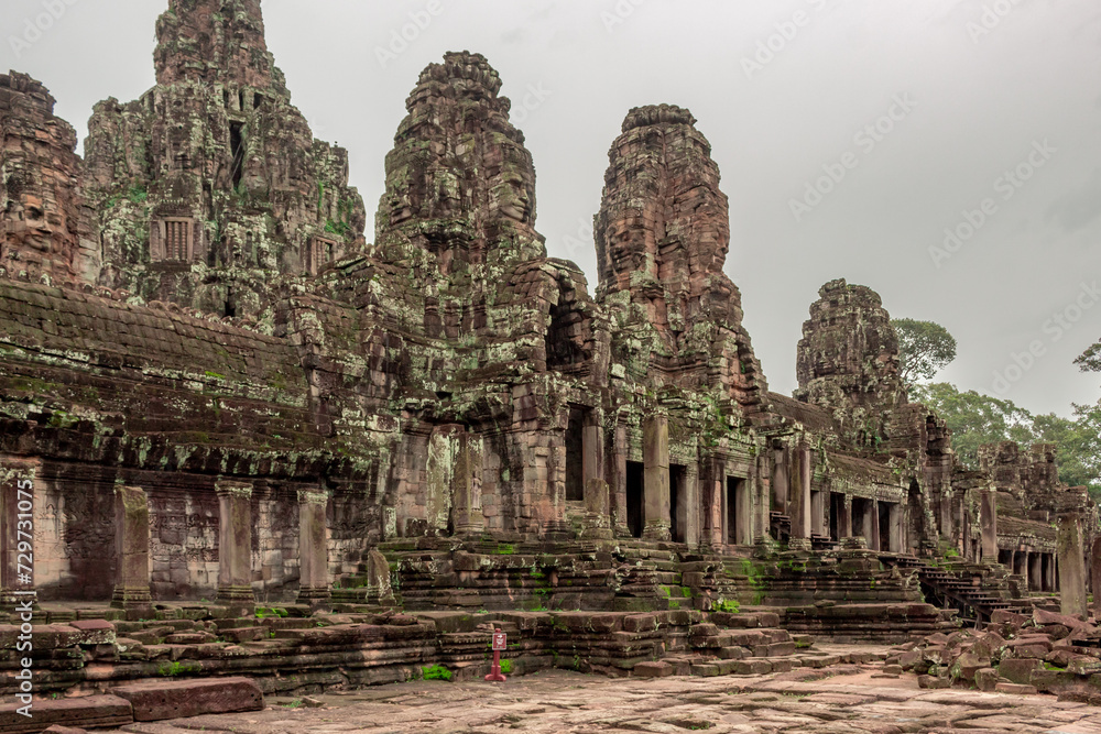 Stone moss covered temple building ruins of the Bayon Temple. Angkor Wat historical site complex, Siem Reap, Cambodia on a cloudy day Stone moss covered temple building ruins of the Bayon Temple. Angkor Wat historical site complex, Siem Reap, Cambodia on a cloudy day