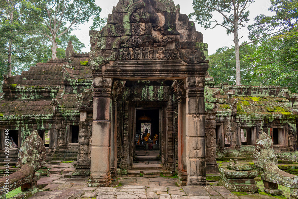 Stone entrance to temple ruin building pagoda architecture of Banteay Srei in Angkor Wat complex historical site in Seim Reap Cambodia on a cloudy overcast day Stone entrance to temple ruin building pagoda architecture of Banteay Srei in Angkor Wat complex historical site in Seim Reap Cambodia on a cloudy overcast day