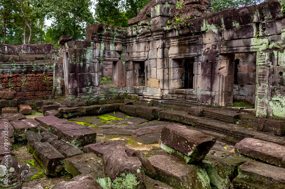 Moss covered green stone temple exterior and bricks at the Chau Say Tevoda Raider Temple complex wall in Angkor Wat historical site park, Seim Reap, Cambodia Moss covered green stone temple exterior and bricks at the Chau Say Tevoda Raider Temple complex wall in Angkor Wat historical site park, Seim Reap, Cambodia