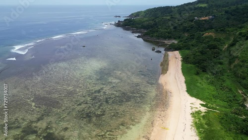 Puraran baras with clear waters, coral reefs, sandy beach and lush greenery, aerial view photo