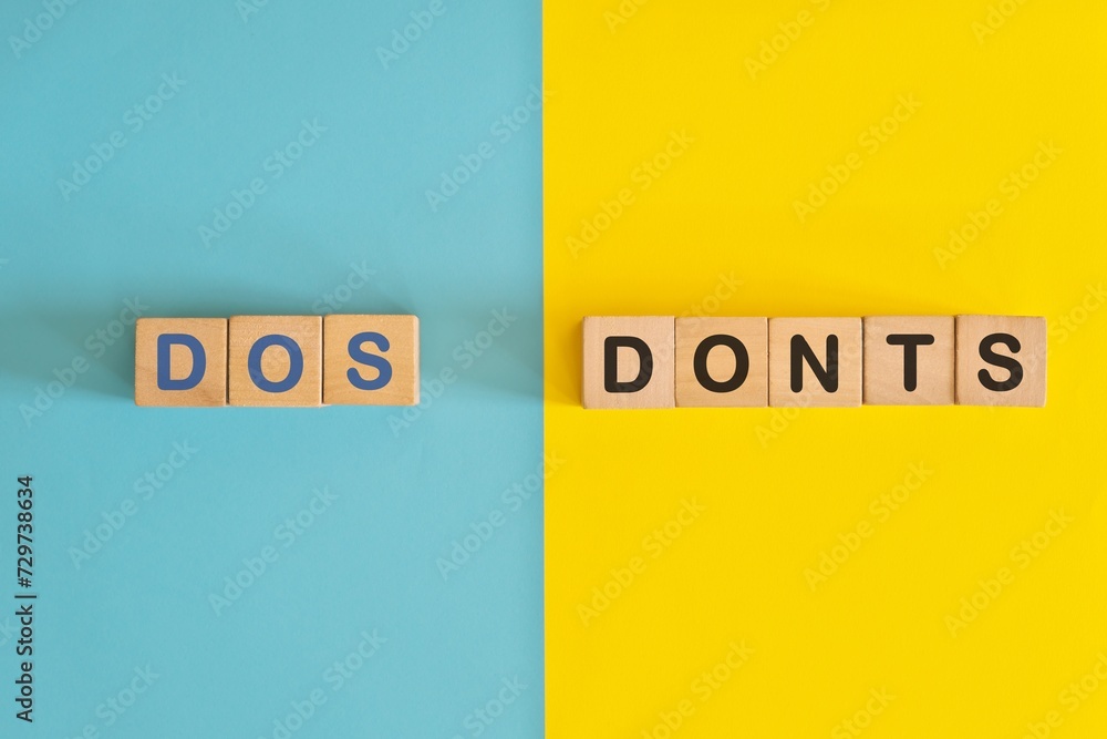 Dos and Donts concept. Wooden blocks typography in bright blue and yellow background.