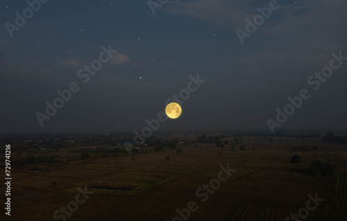 Beautiful moon over rice fields at night in summer