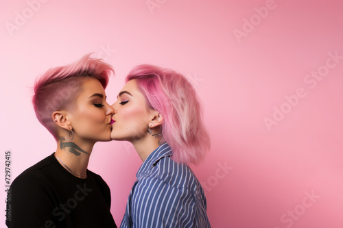 Two pretty stylish cool generation girls. lgbtq lesbian couple dating in love hugging enjoying intimate  sensual moment  together holding hands isolated on pink background. Close up view