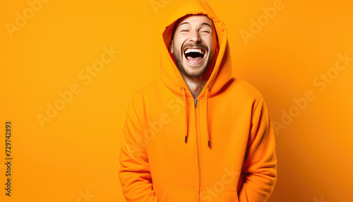 Infectious Laughter Man in Orange Hoodie on Vivid Background