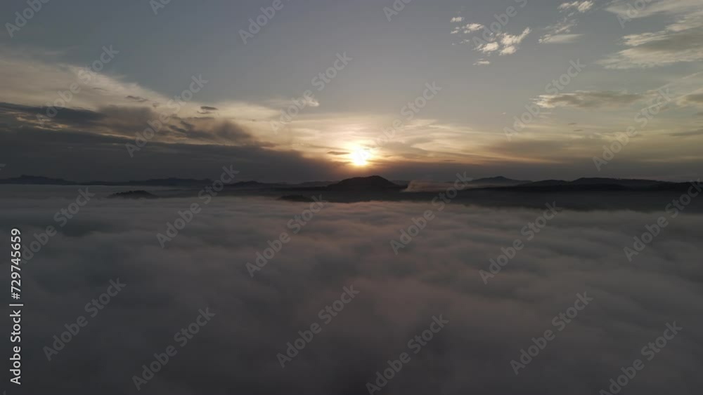Forward scene above the clouds whit a sunset and mountains in the background Forward scene above the clouds whit a sunset and mountains in the background