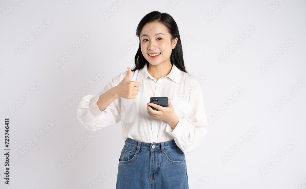 Portrait of young Asian businesswoman using phone on white background Portrait of young Asian businesswoman using phone on white background