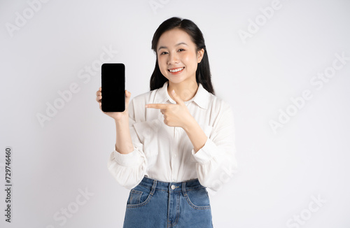 Portrait of young Asian businesswoman using phone on white background