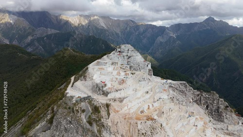 The apuane alps in tuscany showing the rugged texture of a marble quarry, aerial view photo
