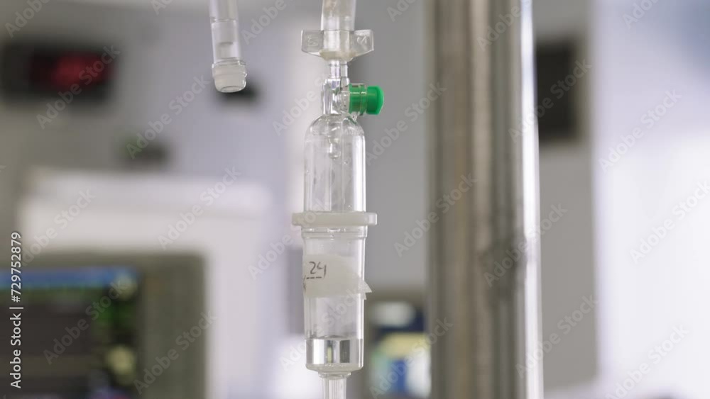 Close up of an intravenous drip with anesthetic on a surgery room during daytime. Close up of an intravenous drip with anesthetic on a surgery room during daytime.