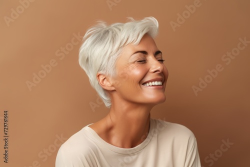 happy middle aged woman with closed eyes and closed eyes on brown background