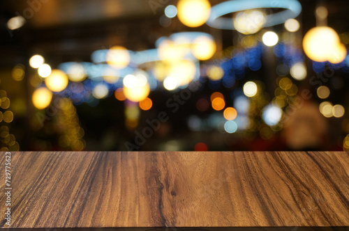 Empty dark wooden table in front of abstract blurred boken bankground of restaurant. Can used for display or montage your products. Mock up for space.