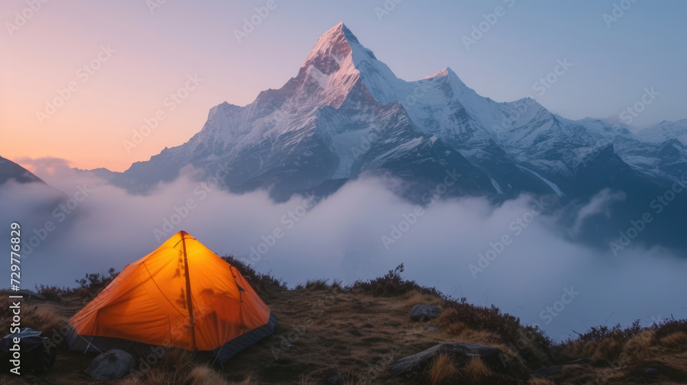 Camping tent of a hiker at beautiful Himalaya area on his travel in the misty morning sunrise.