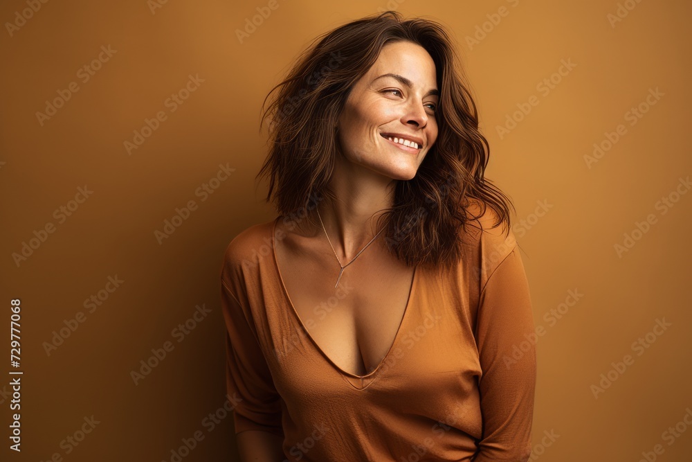 Portrait of a smiling young woman in casual clothes on brown background Portrait of a smiling young woman in casual clothes on brown background