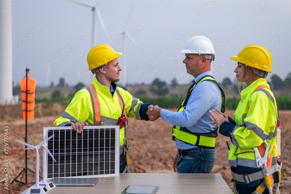 Engineers and manager wearing uniform holding solar call panel work cooperate hand teamwork in