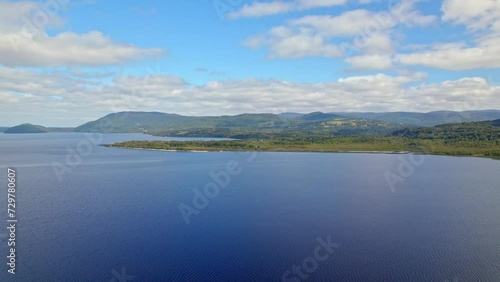 Ascending flyover of Huillinco Lake on a sunny day, Chonchi, Chiloé Island, Chile photo