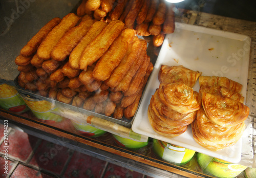 Zoolbia, deep fried pastry with saffron sugar syrup. bamieh,Persian doughnuts with saffron and rose water. photo