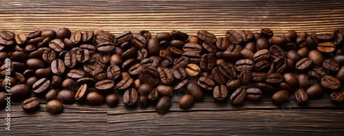 Fresh coffee beans placed on a wooden table © BISMILAH