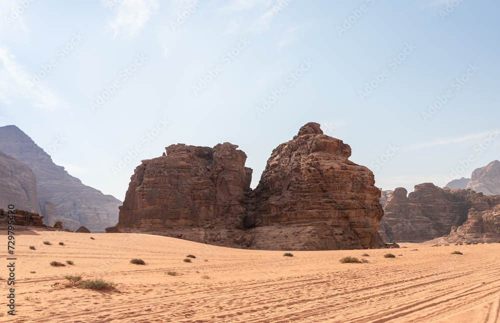 Jeep tire tracks in endless sandy red desert of Wadi Rum near Amman in Jordan Jeep tire tracks in endless sandy red desert of Wadi Rum near Amman in Jordan