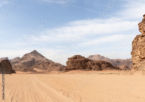 Tread marks from the off road vehicle tires in the red desert surrounded by the high mountains in the the Wadi Rum desert near Amman in Jordan